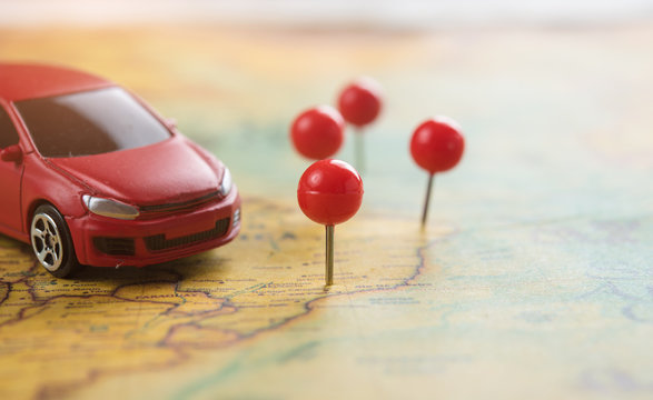 Travel and Transportation concept,Red miniature car on the map - Powered by Adobe