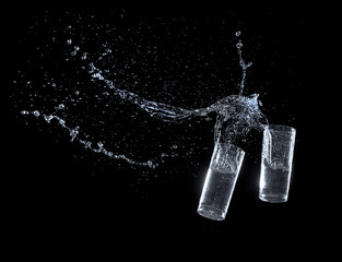 Water splashing from glass isolated on black background