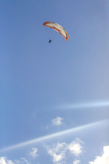 Paragliding on the blue sky and sea background, group of paragliders flying