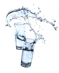 Water splashing from glass isolated on white background