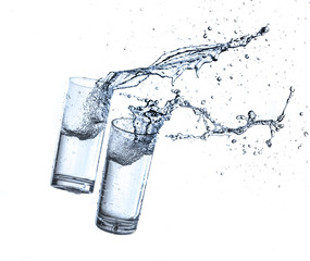 Water splashing from glass isolated on white background