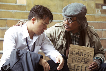 Business man sad and homeless man on street in the captital city.