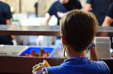 A girl waits for lunch at the cafeteria