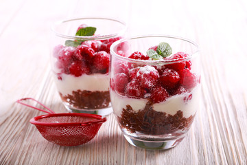 Raspberry layered dessert served in glasses,