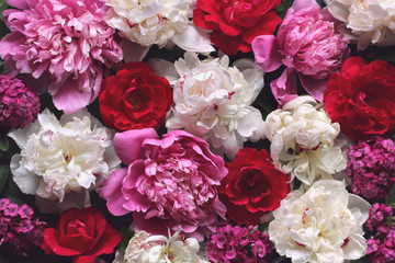 Beautiful floral background with roses and peonies, top view.