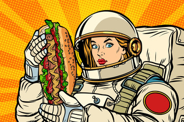 Hungry woman astronaut with hot dog