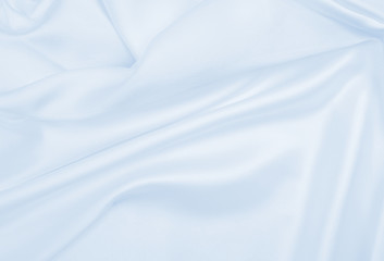 Smooth elegant blue silk or satin luxury cloth texture as abstract background. Luxurious background design