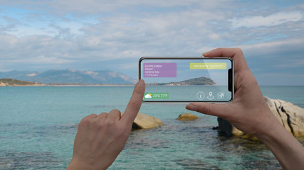 Augmented reality marketing and travel purpose concept. Hand holding smart phone use AR application...