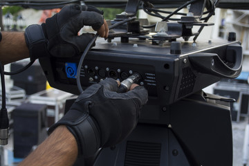 stage lights and metal frame; spotlights equipment and light designer doing concert preparation