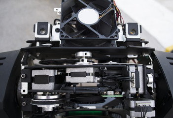 The lighting engineer repairs the light device on stage