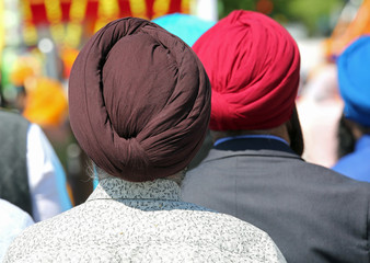 Barefoot Sikh men with turbans  during a ceremony