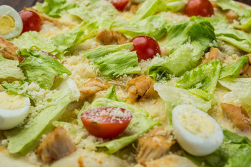 Pizza Caesar with chicken and tomatoes on wooden background