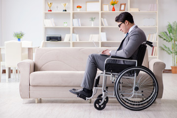 Dsabled businessman on wheelchair working home