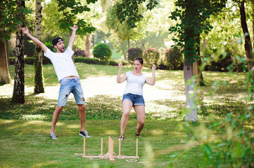 Guy and girl compete in the ring toss