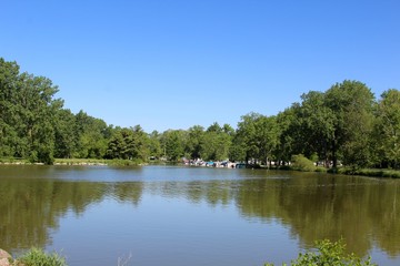 The reflecting lake in the park on a summer sunny day.