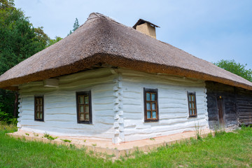 Old wooden house, with a thatched roof,  outside the city of Kiev, Ukraine