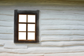 Old retro window with wooden shutters and wooden walls. vintage hut window