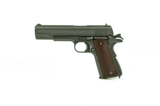 Profile view of isolated semi-automatic airsoft handgun. Replica of real handgun on white background.