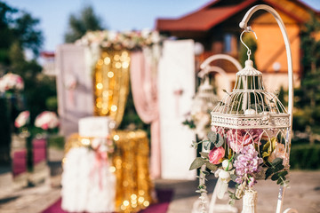 Wedding Banquet hall decorated with flowers, table setting, floral arrangements in the restaurant.