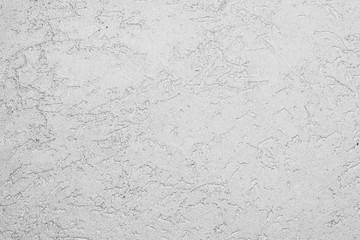 texture of the surface of the wall covered with decorative plaster of the woodworm type, close-up architecture abstract background