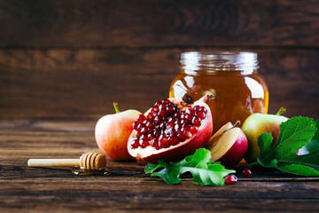Jewish holiday Rosh Hashanah, Apples Honey and Pomegranate on the Wooden Table, Copy space