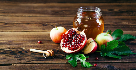 Jewish holiday Rosh Hashanah, Apples Honey and Pomegranate on the Wooden Table, Copy space