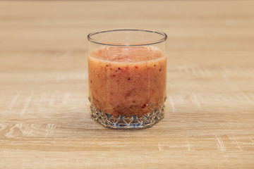 Glass of healthy cocktail with chia seeds, mango,raspberry and coconut water