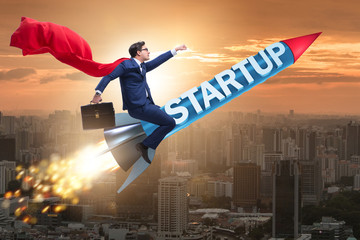 Superhero businessman in start-up concept flying rocket