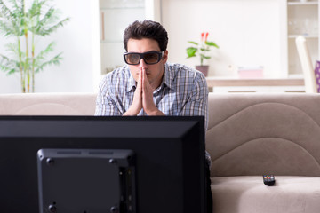 Man watching 3d tv at home