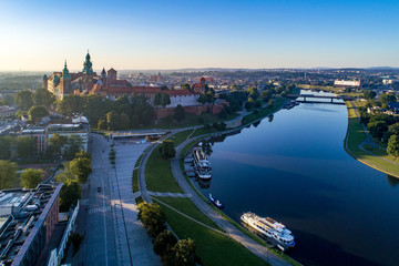 Krakow, Poland. Aerial panorama in sunrise light with Wawel Castle and Cathedral, Vistula River, harbor and tourist ship