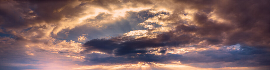 Obraz premium Beautiful sunset sky with clouds and orange strip along the horizon.