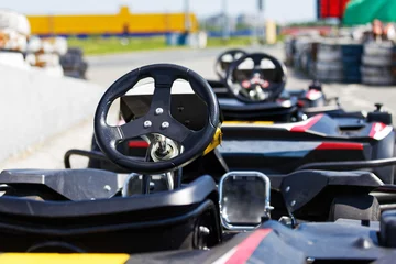 Fototapeten Kart cars parked next to track in anticipation of drivers. Shallow focus. © mark_ka