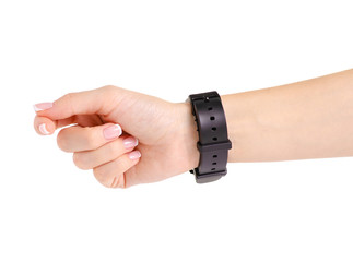 Fototapeta premium Female black watch on the hand of a rubber bracelet on a white background isolation