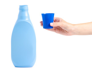 Bottle with the conditioner for linen clothes in hand on a white background isolation