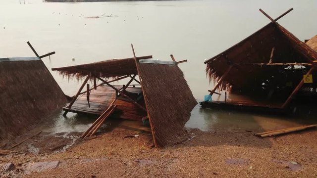 Damaged and broken collapsed hut or houseboat after rainstorm