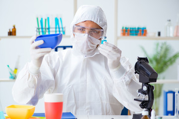 Chemist checking and testing plastic dishes