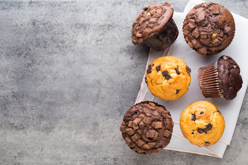 Homemade chocolate muffins on the vintage background.