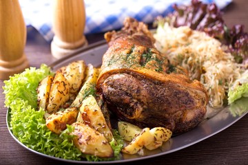 Roasted pork knuckle with fried sauerkraut and fried potato