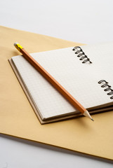 open notebook with pencil on white background office