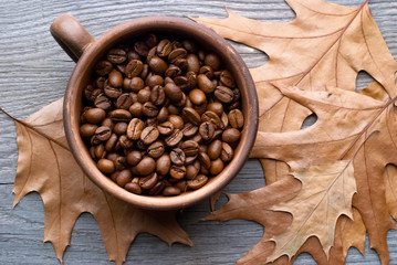 cup with coffee beans on a wooden background
