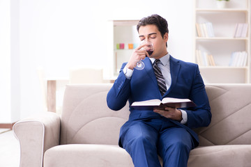 Fototapeta premium Businessman drinking wine sitting at home