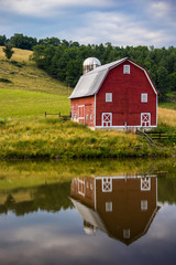 Red barn reflected in pond © Deidre