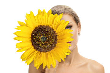Beautiful young woman with sunflower in her hands
