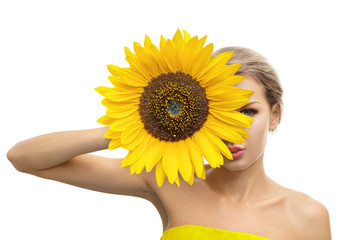 Beautiful young woman with sunflower in her hands