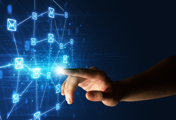 Female finger touching a beam of light surrounded by a blue graphic with envelopes