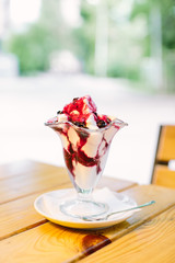 Ice cream in two retro metal bowls on a wooden table.