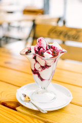 Ice cream in two retro metal bowls on a wooden table.