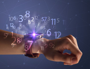 Close up female naked hand wearing smartwatch and numbers around