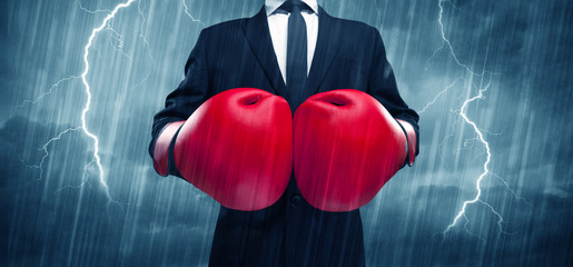 A dangerous sales person getting ready for a fight concept with red boxing gloves and thunder...
