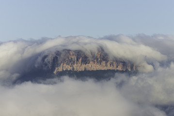 Morning view of the "Wei-Assipu-tepui" (also known as Little Roraima or Roraimita), as it appears among clouds. Canaima National Park, Venezuela 